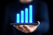© AA - A person holding a smartphone with a glowing blue bar graph on the screen