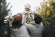 © sonyachny - Happy family having fun with cute baby son in autumn woods in soft evening light. Parenthood. Mother father and little child in cozy stylish clothes smiling in fall park