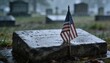 © Future Vision - Showing flat gravestone collecting raindrops at cemetery, with miniature American flag