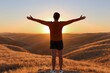 © oksa_studio - Woman feeling freedom with arms open at sunset