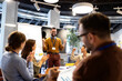 © littlewolf1989 - Business success celebration with happy team members clapping for a triumphant male leader during office meeting