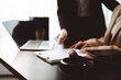 © Daenin - Legal professionals analyzing a contract document with a pen, laptop, gavel, and law book on a dark desk, representing legal consultations, agreements, and courtroom proceedings