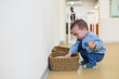 © leungchopan - Little boy finding toy inside basket in playhouse