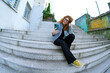 © DondykRiga - Young woman taking selfie on urban stairs