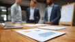 © Thares2020 - Three professional colleagues collaborate on business strategy and plan organizational goals in a modern office setting