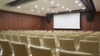 © SI Creative Studio - A modern corporate conference room with rows of chairs facing a large screen