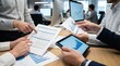 © DailyStock - Business team analyzing financial data and growth charts on paper documents and a digital tablet screen during a collaborative office meeting session