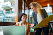 © ADDICTIVE STOCK - Business women discussing project in cafe with laptop