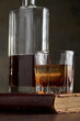 © ADDICTIVE STOCK - Still life with whisky bourbon glass, bottle, and book