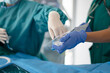 © ADDICTIVE STOCK - Hand of doctor preparing tracheotomy kit in ICU emergency care