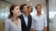 © Thares2020 - Two professionals are shown in a modern office setting interacting and posing through a glass partition