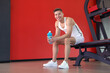© New Africa - Happy young man with protein shake in gym, space for text