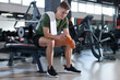 © New Africa - Happy young man with protein shake in gym