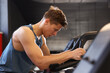© New Africa - Man sweating while training on stationary bicycles in gym