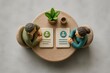 © Leo Rohmann - Top view of two clay figurines in a business meeting at a round table with notebooks and a small plant