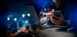 © Zerofukuman - Online payment fraud detection and cybersecurity threat alert concept. Man using smartphone and laptop with credit card, warning icon, and digital security interface for mobile banking safety