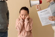 © Pixel-Shot - Sad little girl and her parents getting divorce on beige background
