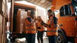 © Khawla - In a logistics retail warehouse, a worker loads cardboard boxes into a delivery van while a female boss uses a tablet computer. Online ordering and purchases