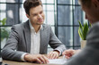 © ASDF - Young man smiles confidently during business meeting