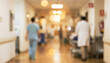 © Vhagar - A blurred image of a hospital corridor, showcasing healthcare professionals in scrubs and a lab coat, emphasizing a busy medical environment.