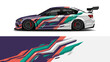 © Lailatul - Vibrant multicolored racecar with dynamic graphics and aerodynamic design on a race track.