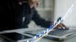 © InfiniteFlow - A businessperson analyzes financial data using a laptop, with visualized growth graphs overlaying the scene, representing strategic investment decision-making in a modern office environment. Copula