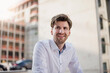 © Westend61 - Portrait of smiling businessman in the city