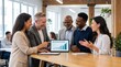 © Tatyana - Group of diverse business professionals discussing Q3 sales success while reviewing data on a tablet in a modern office environment with large windows and wooden beams