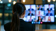 © Curioso.Photography - Businesswoman leading virtual video conference meeting with diverse remote team on digital screens in modern office.