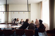 © Johnér - Male and female business professionals sharing marketing ideas while sitting in office meeting room