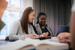 © Johnér - Multiracial female colleagues talking with each other in meeting at office