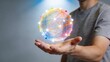 © Husen - A man displays a glowing network sphere in his hand indoors.