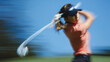 © Anastasiya Ri - Female golfer swinging club during dynamic motion blur on sunny golf course for professional sports training and active lifestyle concepts
