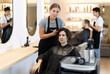 © JackF - Young female hairdresser stylist gives haircut to adult female client in salon