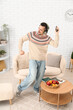 © Pixel-Shot - Handsome man with headphones dancing in living room
