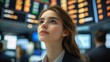 © bright - business professional in blazer looking upward on busy trading floor with glowing electronic stock boards and blurred colleagues, focused and contemplative