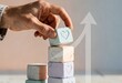 © Ryzhkov - Hand placing a heart icon block on a stack with a rising arrow for relationship growth, social media engagement and emotional wellness marketing