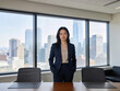 © StockPhotoRepublic - Confident businesswoman standing in boardroom with city skyline behind