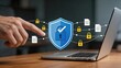 © Jieun - Cyber security protection concept with blue shield icon and padlock on laptop screen, hand touching digital interface for secure data privacy, network safety and antivirus