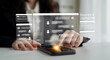 © InfiniteFlow - A close-up view of a professional using a touchscreen device enhanced with AI technology, showcasing modern communication solutions and innovative interface design in a busy workspace. Ledger