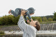 © Anna - sweet young mother plays with little baby, lifting her up in arms. Happy Mother's Day. The joy of motherhood, funny moments with your child. Fun games together
