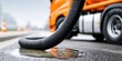 © NovaVision - Truck discharging liquid onto asphalt roadway