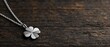 © Phanupong - Four-leaf Clover Pendant Necklace Resting on Rustic Dark Wooden Background for Lucky Charm Jewelry Concept and Elegant Natural Symbol Lifestyle Product Presentation