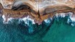 © Yuka - overhang. Aerial view of ocean waves eroding the base of a coastal cliff. ESG reports, sustainability campaigns, designed for environmental awareness campaigns, used by policy analysts.