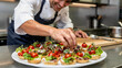 © Thanawadee - Close-up of Smiling Male Chef Preparing Elegant Catering Canapes