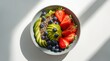 © Tharusha - Healthy breakfast bowl with fresh avocado strawberries and blueberries