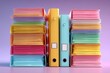 © nameera_juwairiya - Colorful document binders stacked with papers in studio lighting