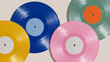 © Yuliia Yevdokymova - Four colorful vinyl records arranged on plain beige surface flat lay mockup, concept for retro music, analog sound, nostalgia, dj culture