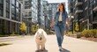 © Konstantin - Young woman walking a fluffy white dog on a sunny city sidewalk near modern apartment buildings, smiling and enjoying an active urban stroll