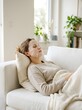 © SITI - Relaxed Young Woman Wearing Sheet Mask on Face Lying on Comfortable Sofa inside Bright Living Room